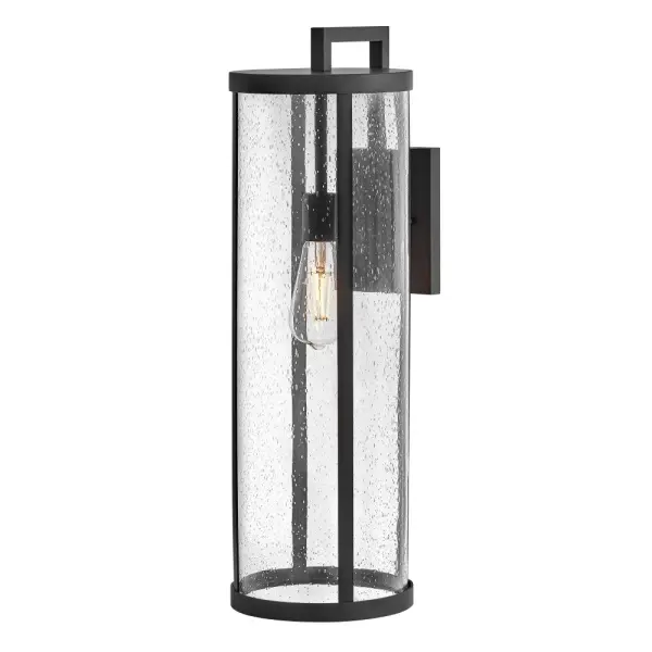 The Alfie Large Wall Lantern combines transitional style with practical outdoor lighting. Its cylindrical design and clear seedy glass create visual interest while the substantial 24-inch height makes a statement on larger exterior walls. - alternate view