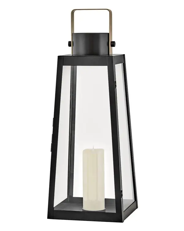 The Hugh Large Decorative Lantern combines bold trapezoidal design with over-scaled clear glass panes and a sleek metal frame. Battery-operated LED faux flame candle included for cordless convenience indoors or out. - alternate view