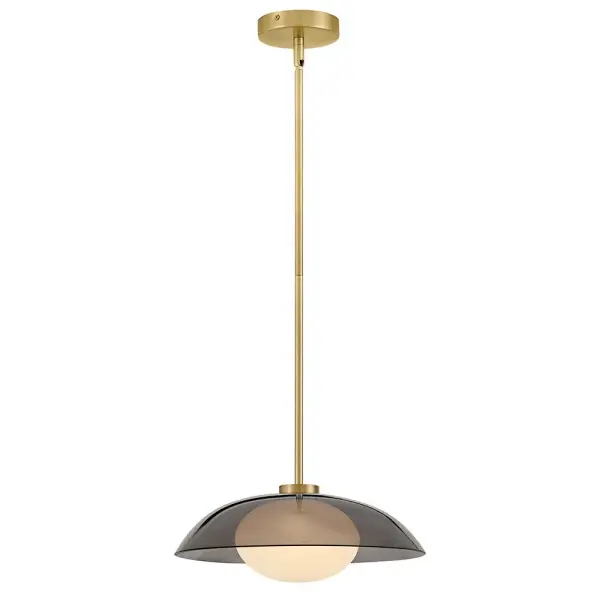 The Jace pendant combines smoke glass over a swirled glass globe for a sophisticated layered effect. Its lacquered brass finish adds warmth while the compact 14-inch size makes it versatile for various spaces.