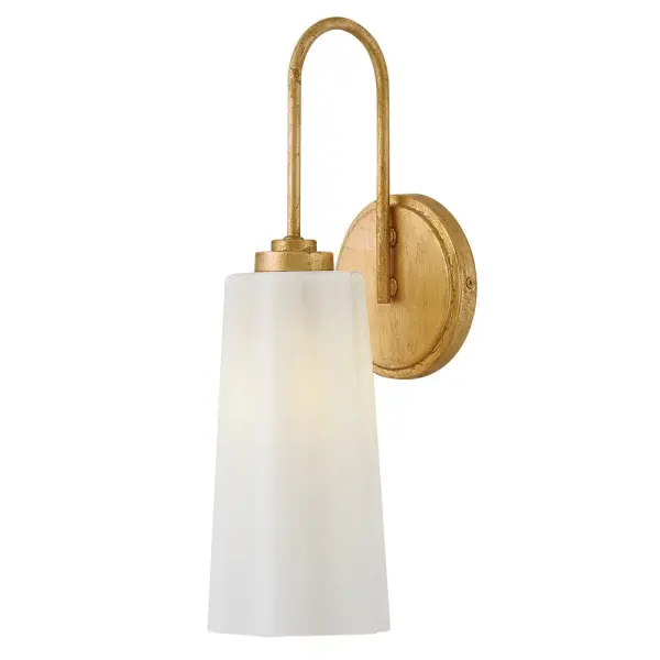 The Honey vanity light combines softly flowing cased opal glass with a modern Distressed Brass finish, creating an elegant fixture that adds lightness and sophistication to bathroom spaces.