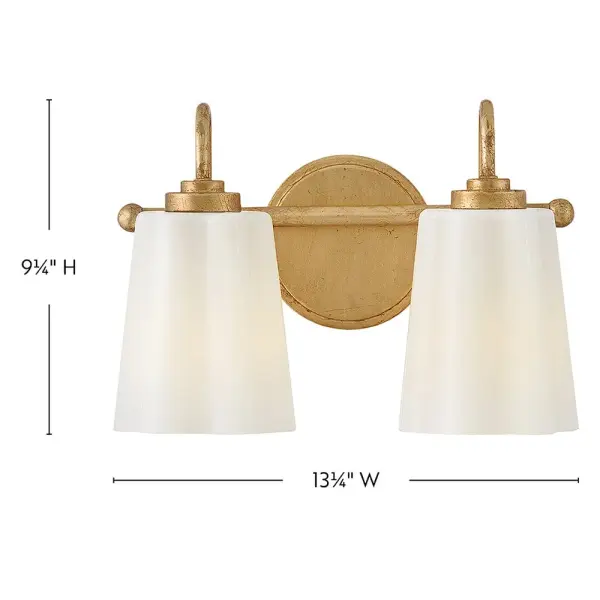 The Honey vanity light combines softly flowing cased opal glass with a distressed brass finish for a charming, versatile look. Its compact 13.25-inch width makes it ideal for smaller bathrooms while providing ample illumination. - alternate view