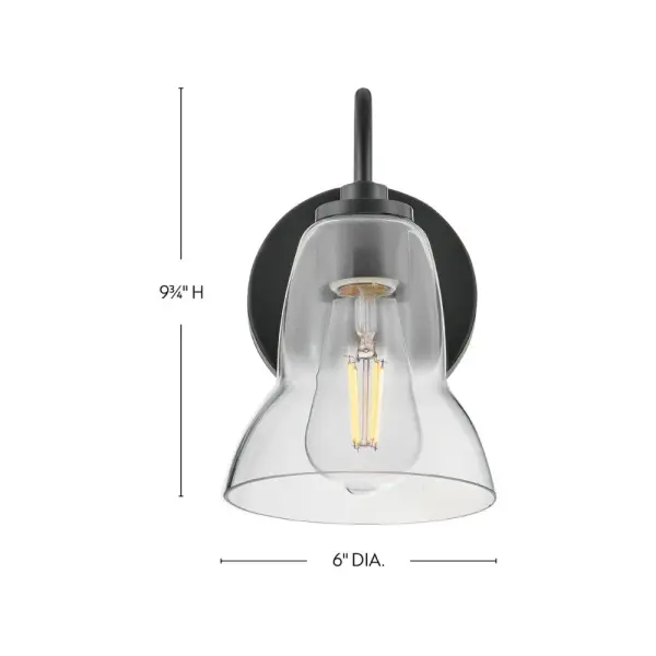 The Vera vanity light elevates traditional bell-shaped design with a unique, shapely form. Clear glass provides excellent up and down illumination, making it ideal for both main baths and powder rooms. The sleek black finish adds modern sophistication. - alternate view