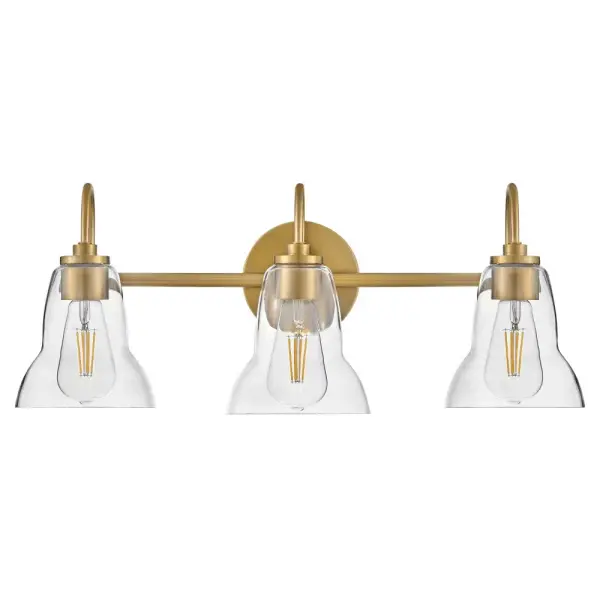 The Vera vanity light elevates traditional bell-shaped shades with a unique, shapely form and clear glass that directs light both up and down. Its lacquered brass finish brings warmth and sophistication to bathrooms.