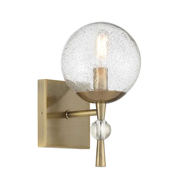 The Populuxe bath lamp combines industrial-modern aesthetics with artisanal craftsmanship. Its oxidized aged brass finish and unique volcanic glass shade create dramatic light diffusion perfect for contemporary bathrooms. - alternate view