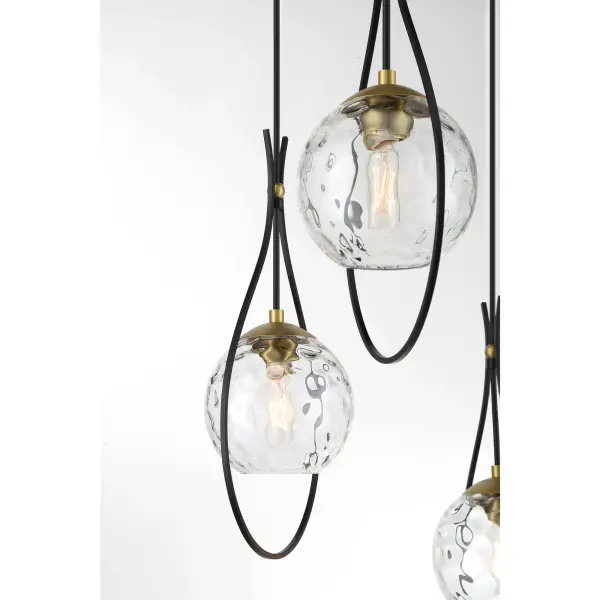 The Cody 3-Light Pan Pendant combines coal black and soft brass finishes with clear water glass for a refined transitional look. Its 19-inch diameter makes it versatile for kitchen islands, dining areas, and entryways. - alternate view