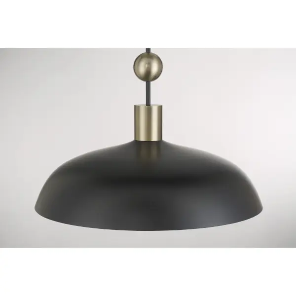 The Biloxi pendant combines coal black steel with weathered antique brass detailing for an industrial aesthetic. Its compact 10.75" size makes it perfect for kitchen islands, breakfast nooks, or clustered installations. - alternate view