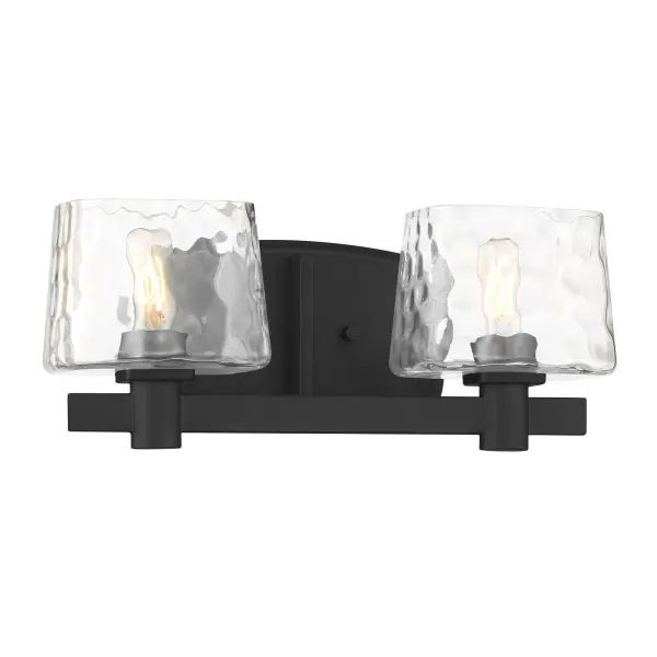 The Drysdale 2-Light Bath Vanity combines modern minimalism with industrial charm. Its coal black finish and clear hammered glass shades create visual interest while the reversible design offers installation flexibility. - alternate view