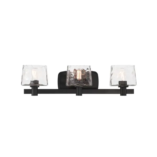 The Drysdale 3-light vanity combines industrial charm with modern functionality. Its coal black finish and hammered glass shades create visual interest, while the reversible mounting offers installation flexibility.