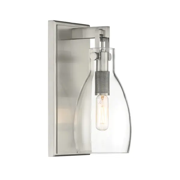The Tiberia bath sconce combines modern styling with practical functionality. Its plated pewter finish and clear glass shade deliver clean, focused light perfect for vanity areas while adding sophisticated style.