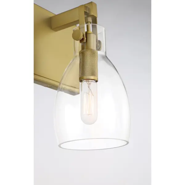 The Tiberia 3-Light Bath Vanity combines warm soft brass finish with clear glass shades for a sophisticated, contemporary look. Perfect for modern bathrooms seeking refined illumination with vintage-inspired charm. - alternate view
