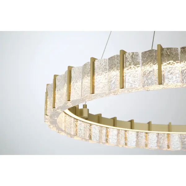 The Sevryn LED Pendant combines contemporary elegance with functional brilliance. Its 36-inch linear design features cast clear textured crystal glass set in soft brass, delivering 3240 lumens of dimmable LED light with exceptional 90 CRI color rendering. - alternate view