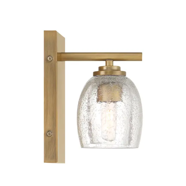The Glint 6" vanity light combines warm Legacy Brass finish with charming seeded glass for a sophisticated yet approachable look. Its compact 6-inch width makes it ideal for powder rooms and smaller bathrooms where space is premium. - alternate view