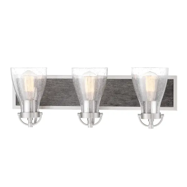 The Garrison 3-Light Bath combines brushed nickel with natural shale wood accents and seeded glass shades for a sophisticated modern-industrial aesthetic. Perfect for medium-sized bathrooms seeking character and ample illumination.