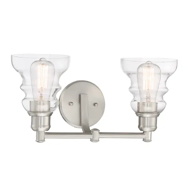 The Waterbury 2-Light Bath fixture combines brushed nickel finish with clear glass shades for a timeless look. Its compact 15.75-inch width makes it ideal for smaller vanities while providing ample illumination.