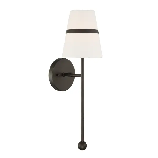 The Althia wall sconce combines textured dark bronze metalwork with a soft white linen shade, creating warm ambient lighting perfect for intimate spaces. Its 20-inch height provides substantial presence without overwhelming.