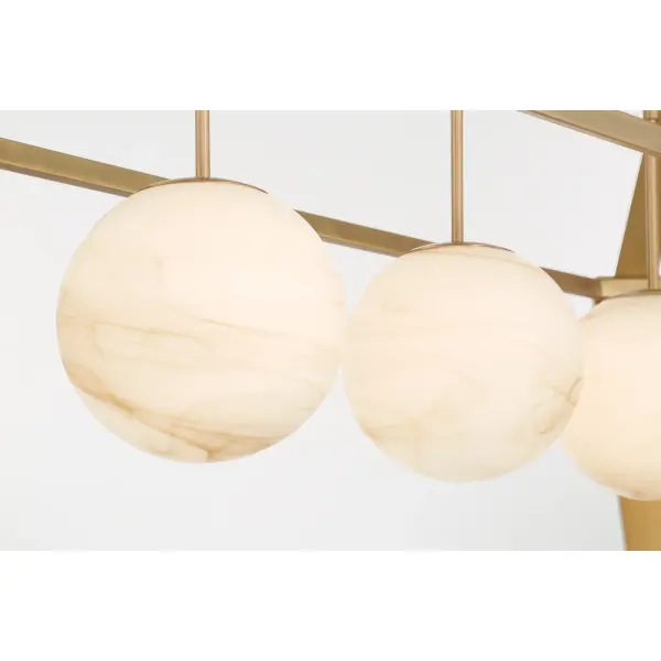 The Shimmer 48" Island Chandelier combines transitional elegance with practical illumination. Its Legacy Brass finish and etched amber swirl glass shades create a warm, inviting glow perfect for kitchen islands and dining spaces. - alternate view