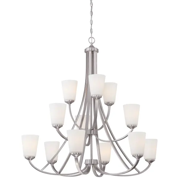 The Overland Park chandelier makes a stunning statement with 12 lights arranged in an elegant configuration. Its brushed nickel finish and etched white glass shades create a sophisticated look that bridges traditional and contemporary styles.
