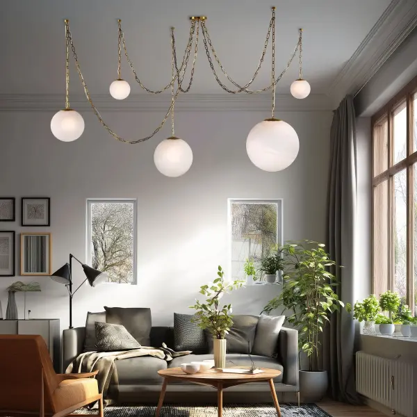 The Marbelle 84.5" pendant makes a dramatic statement with its impressive length and elegant Legacy Brass finish. Five etched alabaster glass shades provide warm, diffused light ideal for large dining tables and kitchen islands. - alternate view