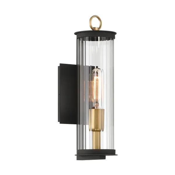 The Cara outdoor wall sconce combines modern industrial aesthetics with practical outdoor lighting. Its compact 14-inch profile features dark matte black finish with legacy brass accents and distinctive ribbed glass.