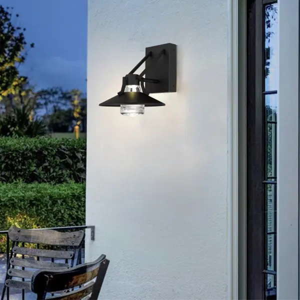 The Radiant sconce combines thick-walled artisan glass with wet-rated durability and 3-CCT dimmable technology. Its transitional design features captivating light interplay through clear glass, making it ideal for outdoor spaces. - alternate view