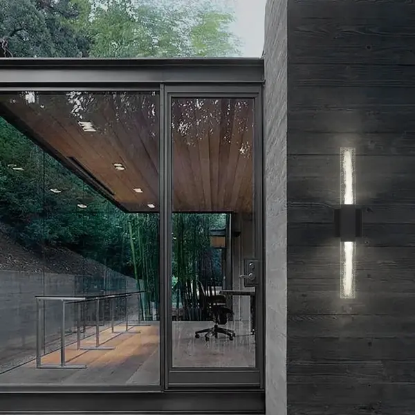 The Folio 24" wall sconce combines modern elegance with practical functionality. Its distinctive clear wispy glass and delicate proportions create visual appeal, while wet location rating, 3-CCT customization, dimming, and ADA compliance make it versatile for both residential and commercial applications. - alternate view