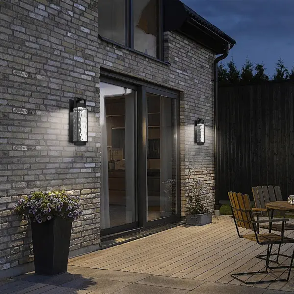 The Winston outdoor wall sconce combines timeless lantern design with contemporary LED efficiency. Featuring exquisite mouth-blown clear hammered glass and customizable 3-CCT color temperature control, it's wet-rated for durability. - alternate view