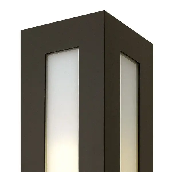 Dorian’s robust design in durable aluminum construction is offered in a Bronze finish. This contemporary fixture allows light to emit from white glass windows. - alternate view