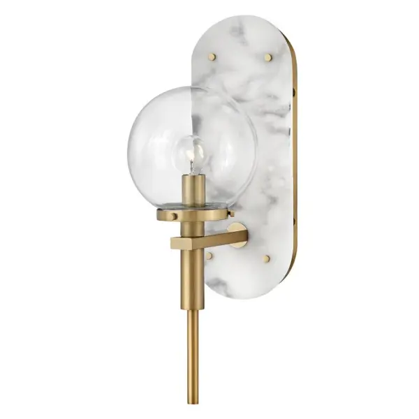 An alluring profile that blends a vintage and modern aesthetic, Gilda is the best of both worlds. This show-stopping sconce showcases a large clear glass globe atop a brass stem with contrasting rivets on a luxurious Black Marble or Faux Alabaster backplate. Gilda features a concealed on/off switch and removable cord and can be hardwired or plugged in.