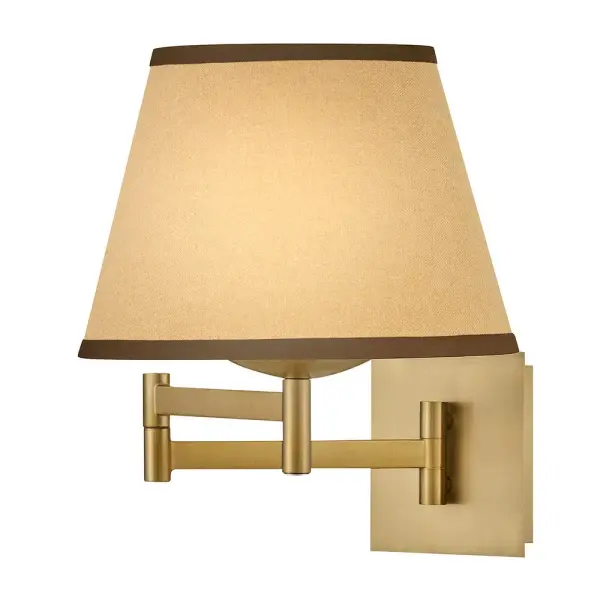 A take on traditional sconce styles, Sonia’s tapered shades feature contrasting top and bottom binding. The chic metal frame and accents are finished in versatile Lacquered Brass to complement any color palette.