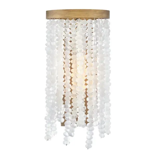 The Dune sconce brings mesmerizing coastal charm with soft sea glass strands and burnished gold finish. Its organic, sun-and-surf inspired design adds timeless elegance to any space while maintaining a sophisticated silhouette.