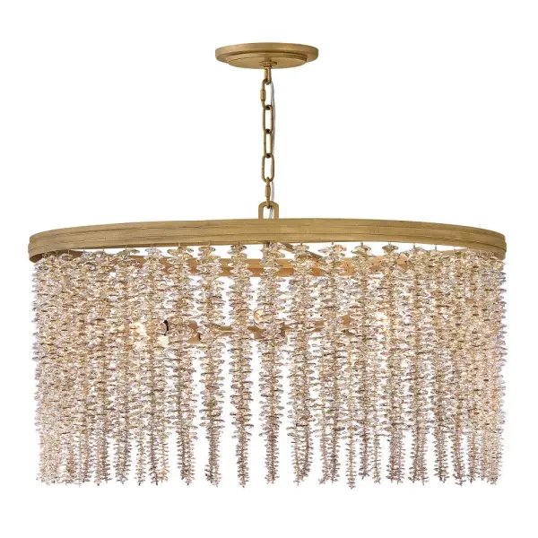The Rubina chandelier delivers show-stopping glamour with individually strung crystal strands that create mesmerizing light refractions. Its traditional tiered design and Burnished Gold finish offer versatile elegance for formal spaces.