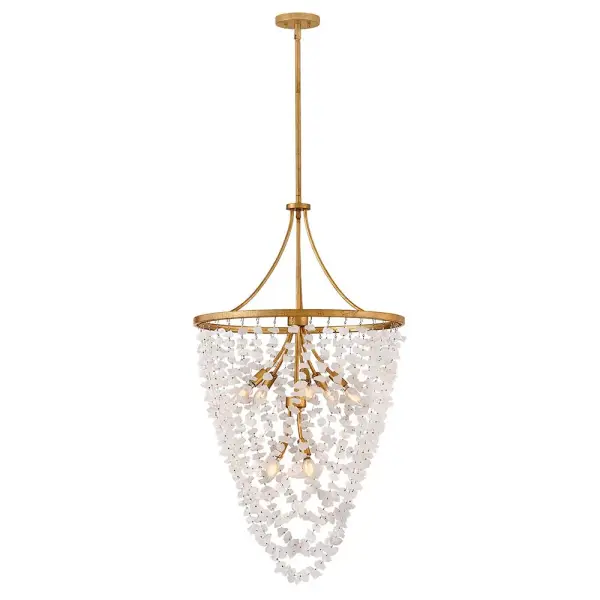 The Myra chandelier combines natural rock crystal beauty with sophisticated brass metalwork. Each uniquely faceted stone creates stunning light reflections, while the distressed brass frame adds warmth and character to any space.
