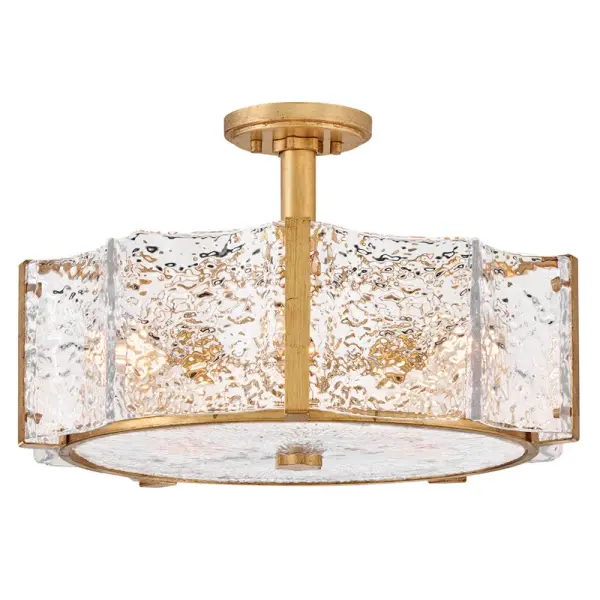 The Florian semi-flush mount combines pressed glass with a flowing, aqueous texture and warm distressed brass finish. Its candelabra lamps create abundant, gently diffused illumination perfect for medium-sized spaces with standard ceilings.