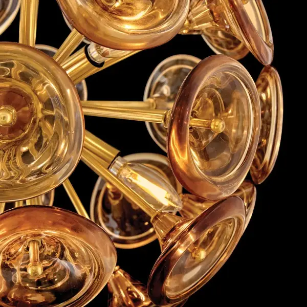 The Maya Large Pendant transforms any space with its artfully arranged hand-blown trumpet glass blossoms and solid brass frame. The unlacquered brass finish develops a beautiful living patina over time, adding character and warmth to contemporary interiors. - alternate view