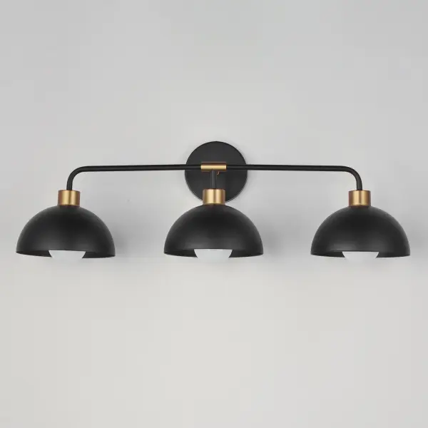 Dome shaped shades in Matte Black contrast Natural Aged Brass accents. Available in flush mount, bath vanity, and swing arm wall sconce configurations. This collection delivers an approachable, modern design that pairs well with transitional design aesthetics. - alternate view