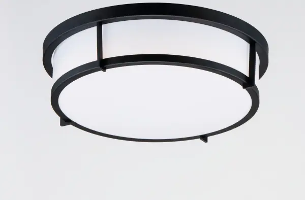 A steel framed acrylic shade transitional flush mount available in a variety of finishes and sizes. Featuring easy accessibility to the shade after installation, the locking mechanism that shade's frame rests on top of making removal quick for keeping clean and replacing lamps over its lifetime. For those who prefer not to re-lamp, an LED option enhances the fixture by evenly dispersing the light across the shade, and it includes additional options made for light commercial applications. This includes an emergency backup battery and range voltage inputs. Available in your choice of Satin Nickel, Satin Brass, and Black and two shade sizes. - alternate view