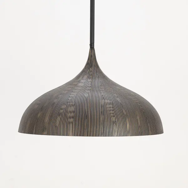 Graceful and sculptural, Fleur's gently flared silhouette brings a sense of quiet sophistication to any space. Hand-spun metal shades are adorned with a striated finish, scraped by hand to reveal glowing Gold undertones beneath layers of Matte Black or White. A matching Gold interior warms the light within, while a coordinating fabric cord suspends them for convenient height adjustments. Offered in multiple pendant sizes and a flush mount, Fleur offers tailored elegance to interior spaces such as entries and over a kitchen island. - alternate view