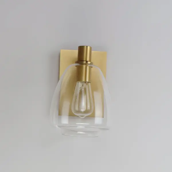 Pendants of Clear glass in unique elongated and undulating shapes with various sizes. This series pairs well with popular finishes in hardware and plumbing, giving you the flexibility to take chances with designer statement pieces. The metalwork is available in your choice of Matte Black, Satin Brass, or Satin Nickel. A coordinating wall sconce pairs well with the collection. Use filament bulbs to complete the look. Collection: Babylon Finish: Satin Brass Glass: Clear Width: 7.25" Height: 10.25" Weight: 3.02 lb Extension from Wall: 9.00" Wire: 8" Canopy: 7.87"x5.5" Number of Bulbs: 1 Maximum Wattage: 6.00 W Bulb Type: T10 Bulb Base: E26 Medium Light Source: LED Color Temperature: 2700 K Dimmable Voltage: 120.00 V Material: Steel+Glass Safety Listing: cETLus Safety Rating: Damp LED Manufacturer Warranty: 3 Spec Sheet Instructions - alternate view