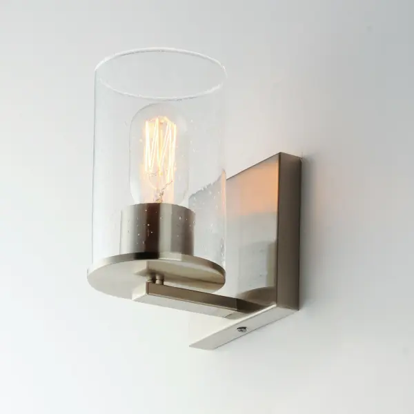 Cylinders in Clear Seeded glass on simple Satin Nickel frames or matte Black frames with Antiqued Brass socket covers. Pivoting arms on chandelier allow it to direct light up or down. Use filament lamps either tubular or Edison in shape for a Coastal or Industrial look, or use a traditional A19 to create a more transitional look. A full range of affordable lighting for the kitchen, dining room, bathroom, or bedroom that easily complements fashionable finishes and lasting styles. Collection: Sleek Finish: Satin Nickel Glass: Seedy Width: 4.75" Height: 7.50" Weight: 0.75 lb Extension from Wall: 5.25" Wire: 8" Canopy: 4.75"x4.75" Number of Bulbs: 1 Maximum Wattage: 60.00 W Bulb Type: A19 Bulb Base: E26 Medium Light Source: Incandescent Voltage: 120.00 V Material: Steel + Glass Safety Listing: cETLus Safety Rating: Damp Manufacturer Warranty: 5 Spec Sheet Instructions - alternate view