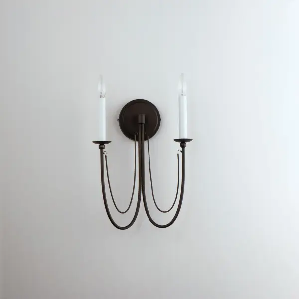 Sweeping metal accents links create classic curves on a minimalist chandelier. Available in hand-rubbed Chestnut Bronze or elegant Gold Leaf finishes. Add crystal accents to elevate the design for a more extravagant glamour. The design manages to evoke French Country charm and enchants any room it illuminates. - alternate view