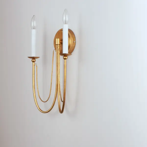 Sweeping metal accents links create classic curves on a minimalist chandelier. Available in hand-rubbed Chestnut Bronze or elegant Gold Leaf finishes. Add crystal accents to elevate the design for a more extravagant glamour. The design manages to evoke French Country charm and enchants any room it illuminates. Collection: Plumette Finish: Gold Leaf Width: 14.00" Height: 16.00" Weight: 1.10 lb Extension from Wall: 5.25" Wire: 8" Canopy: 5"x5" Number of Bulbs: 2 Maximum Wattage: 60.00 W Bulb Type: B11 Bulb Base: E12 Candelabra Light Source: Incandescent Dimmable Voltage: 120.00 V Material: Iron & Crystal Safety Listing: cULus Safety Rating: Dry Manufacturer Warranty: 2 Spec Sheet Instructions - alternate view