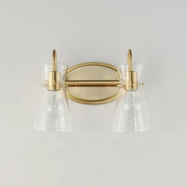 Suspended by three pin connections, the sharp silhouette of Ava's angular glass provides a designer look to enhance your bathroom design. Using Clear glass and a variety of complementary metal finishes the sconces are available in Black, Polished Chrome, or Natural Aged Brass allowing it to pair well with most interior color palettes. Collection: Ava Finish: Natural Aged Brass Glass: Clear Width: 13.50" Height: 9.50" Weight: 2.20 lb Extension from Wall: 7.00" Wire: 6" Canopy: 8"x5" Number of Bulbs: 2 Maximum Wattage: 60.00 W Bulb Type: E26 Bulb Base: E26 Medium Light Source: Incandescent Dimmable Voltage: 120.00 V Material: Steel,Glass Safety Listing: cULus Safety Rating: Damp Manufacturer Warranty: 3 Spec Sheet Instructions - alternate view