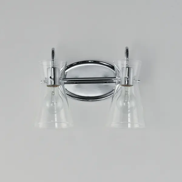 Suspended by three pin connections, the sharp silhouette of Ava's angular glass provides a designer look to enhance your bathroom design. Using Clear glass and a variety of complementary metal finishes the sconces are available in Black, Polished Chrome, or Natural Aged Brass allowing it to pair well with most interior color palettes. Collection: Ava Finish: Polished Chrome Glass: Clear Width: 13.50" Height: 9.50" Weight: 2.20 lb Extension from Wall: 7.00" Wire: 6" Canopy: 8"x5" Number of Bulbs: 2 Maximum Wattage: 60.00 W Bulb Type: E26 Bulb Base: E26 Medium Light Source: Incandescent Dimmable Voltage: 120.00 V Material: Steel,Glass Safety Listing: cULus Safety Rating: Damp Manufacturer Warranty: 3 Spec Sheet Instructions - alternate view