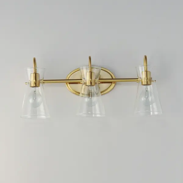 Suspended by three pin connections, the sharp silhouette of Ava's angular glass provides a designer look to enhance your bathroom design. Using Clear glass and a variety of complementary metal finishes the sconces are available in Black, Polished Chrome, or Natural Aged Brass allowing it to pair well with most interior color palettes. Collection: Ava Finish: Natural Aged Brass Glass: Clear Width: 22.00" Height: 9.50" Weight: 3.30 lb Extension from Wall: 7.00" Wire: 6" Canopy: 8"x5" Number of Bulbs: 3 Maximum Wattage: 60.00 W Bulb Type: E26 Bulb Base: E26 Medium Light Source: Incandescent Dimmable Voltage: 120.00 V Material: Steel,Glass Safety Listing: cULus Safety Rating: Damp Manufacturer Warranty: 3 Spec Sheet Instructions - alternate view