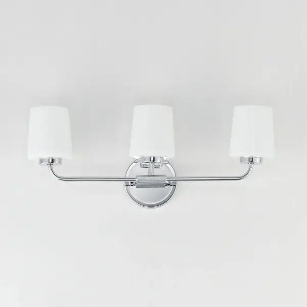 Featuring knurled rod details, this lighting collection brings a modern industrial edge to any space. Available in a range of sizes for chandeliers and two styles of bath vanity lighting, it offers versatility for different design needs. Offered in Matte Black, Satin Nickel, and Natural Aged Brass, this collection complements a wide variety of interior styles. Collection: Durham Finish: Polished Chrome Glass: White Width: 23.00" Height: 9.25" Weight: 6.00 lb Extension from Wall: 5.50" Wire: 8" Canopy: 5"x5" Number of Bulbs: 3 Maximum Wattage: 60.00 W Bulb Type: A19 Bulb Base: E26 Medium Light Source: Incandescent Dimmable Voltage: 120.00 V Material: Steel, Glass Safety Listing: cULus Safety Rating: Damp Spec Sheet Instructions - alternate view