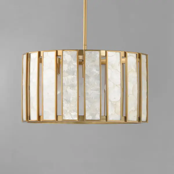 Classic in form and evoking the sea, laminae of Capiz shell are framed in paneled drum shapes. The Natural Aged Brass finish refines the coastal elements and complements the warm glow from behind the translucent panels. Available in multiple configurations of pendants as well as tiered chandeliers as well as a tall ADA-compliant wall sconce, the collection offers a sophisticated approach to coastal design. - alternate view