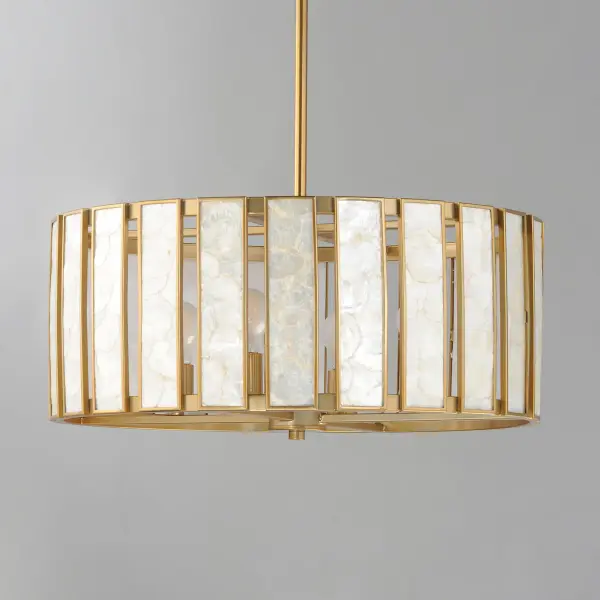 Classic in form and evoking the sea, laminae of Capiz shell are framed in paneled drum shapes. The Natural Aged Brass finish refines the coastal elements and complements the warm glow from behind the translucent panels. Available in multiple configurations of pendants as well as tiered chandeliers as well as a tall ADA-compliant wall sconce, the collection offers a sophisticated approach to coastal design. - alternate view