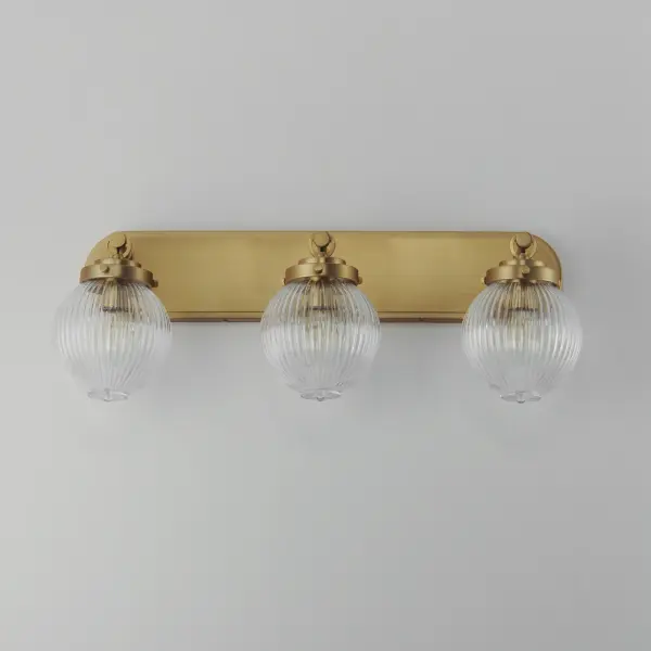 Nostalgic spherical glass volumes with a ribbed pattern and a dipped flat bottom, this collection offers a retro and eclectic choice for pendants and sconces. Available in Oil Rubbed Bronze, Satin Brass, and Satin Nickel, these fixtures provide elegant illumination, adding distinctive style to common spaces. Collection: Kasbah Finish: Satin Brass Glass: Clear Ribbed Width: 25.50" Height: 9.50" Weight: 7.56 lb Extension from Wall: 7.75" Wire: 8" Canopy: 4.5"x24" Number of Bulbs: 3 Maximum Wattage: 60.00 W Bulb Type: A19 Bulb Base: E26 Medium Light Source: Incandescent Dimmable Voltage: 120.00 V Material: Steel, Glass Safety Listing: cETLus Safety Rating: Damp Spec Sheet Instructions - alternate view