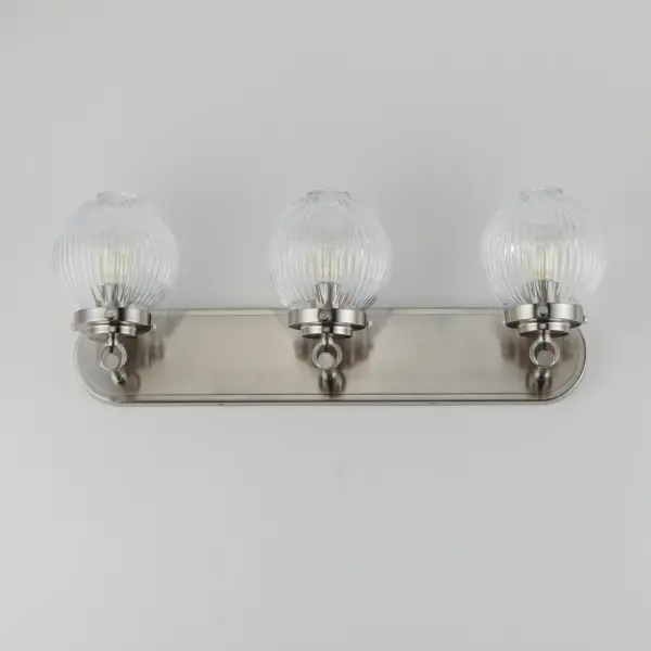 Nostalgic spherical glass volumes with a ribbed pattern and a dipped flat bottom, this collection offers a retro and eclectic choice for pendants and sconces. Available in Oil Rubbed Bronze, Satin Brass, and Satin Nickel, these fixtures provide elegant illumination, adding distinctive style to common spaces. Collection: Kasbah Finish: Satin Nickel Glass: Clear Ribbed Width: 25.50" Height: 9.50" Weight: 7.56 lb Extension from Wall: 7.75" Wire: 8" Canopy: 4.5"x24" Number of Bulbs: 3 Maximum Wattage: 60.00 W Bulb Type: A19 Bulb Base: E26 Medium Light Source: Incandescent Dimmable Voltage: 120.00 V Material: Steel, Glass Safety Listing: cETLus Safety Rating: Damp Spec Sheet Instructions - alternate view