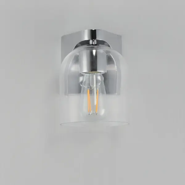 Cut-out metalwork curves around modern bell-shaped glass shades. The series includes pendants and bath vanities available in either Clear or a swirling Marble glass. Available in various complementary finishes: Polished Chrome, Matte Black, or Natural Aged Brass these fixtures make a delightful addition to bathroom spaces, bedrooms, or over a kitchen island. Collection: Scoop Finish: Polished Chrome Glass: Clear Width: 5.50" Height: 7.25" Weight: 1.98 lb Extension from Wall: 6.25" Wire: 6" Canopy: 4.75"x4.75" Number of Bulbs: 1 Maximum Wattage: 60.00 W Bulb Type: E26 Bulb Base: E26 Medium Light Source: Incandescent Dimmable Voltage: 120.00 V Material: Steel, Glass Safety Listing: cULus Safety Rating: Damp Spec Sheet Instructions - alternate view